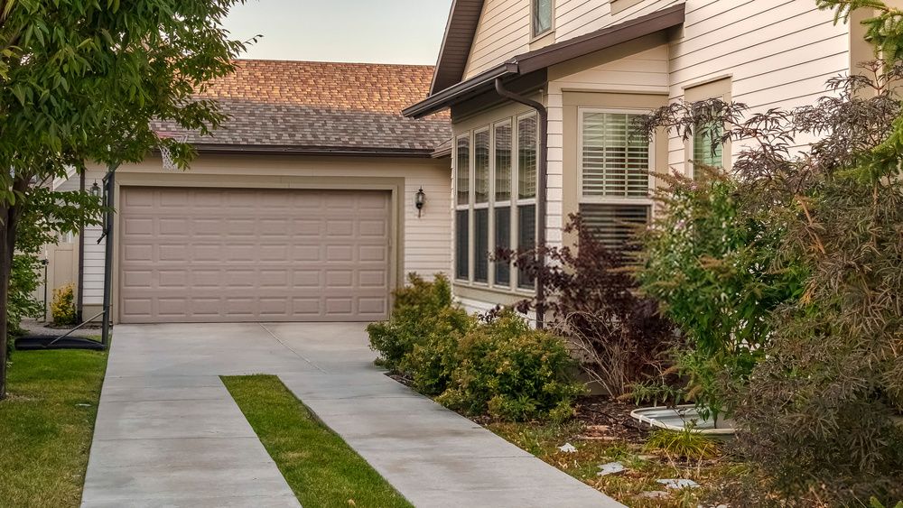artificial turf installed between concrete pavers to create a modern-looking driveway in Tempe, AZ