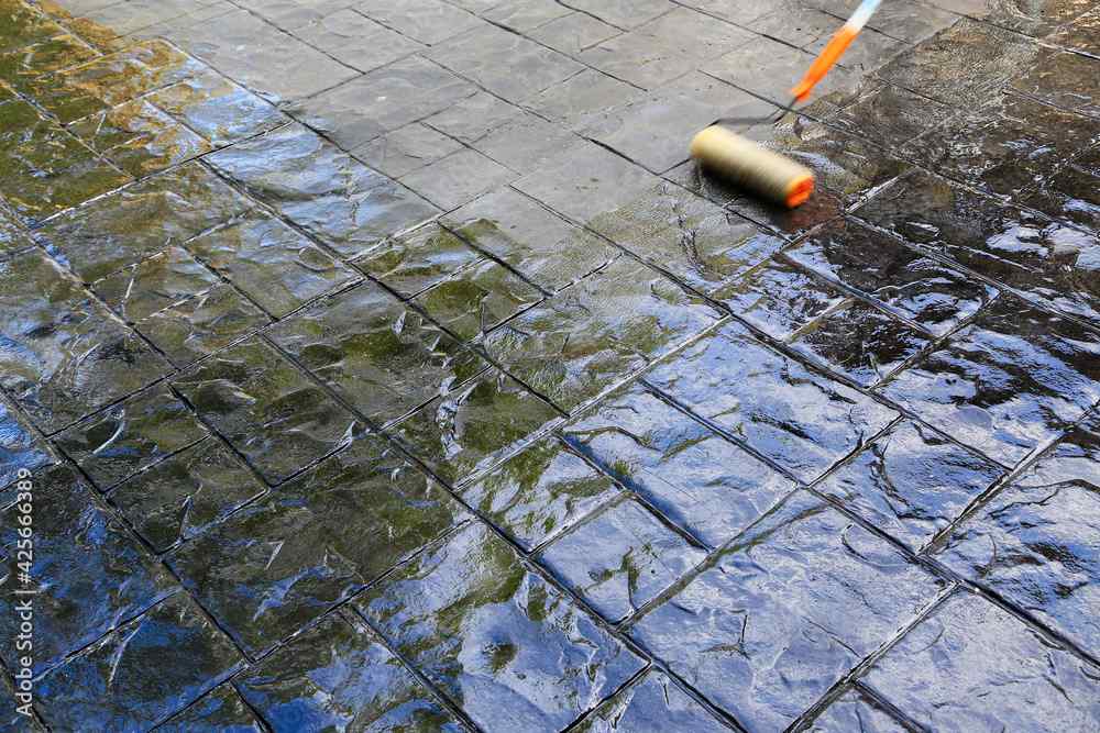 this stamped concrete patio in Gilbert, AZ is polished using a paint roller